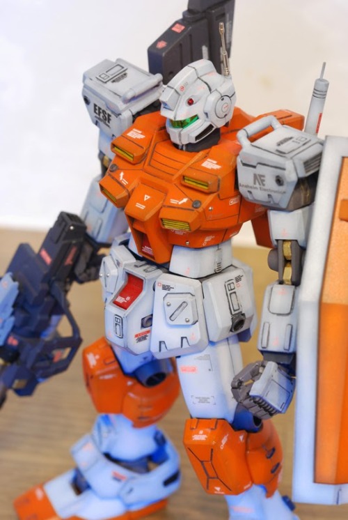 galaxyjunkyard:  hangmen13:  Powered GM custom built by clubmanKS Base Gunpla: HGUC 1/144 Powered GM  Another stunning Gundam custom, and we love the orange. 
