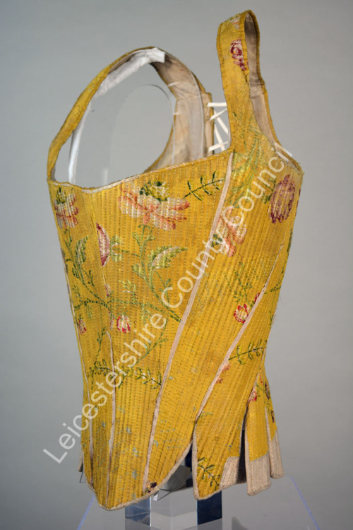 symingtoncorsets: Corset made from yellow silk brocade and trimmed with white leather. It dates from