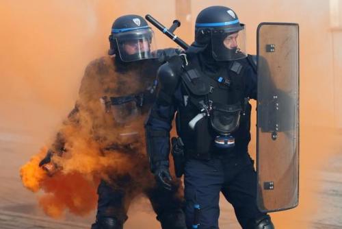  French CRS riot police face off with protestors during a demonstration against French government re