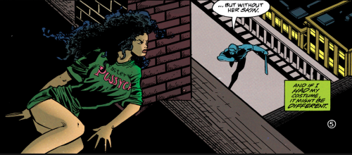 panel from Catwoman vol 2 #53 showing Selina Kyle wearing a long green shirt that goes past her hips hiding behind a chimney on a room watching a guy with a machete below her, she's lying down in a boobs and butt pose with her butt facing to the left and showing both buttcheeks under her shirt to the audience, and her chest tilted upwards and facing the audience viewpoint