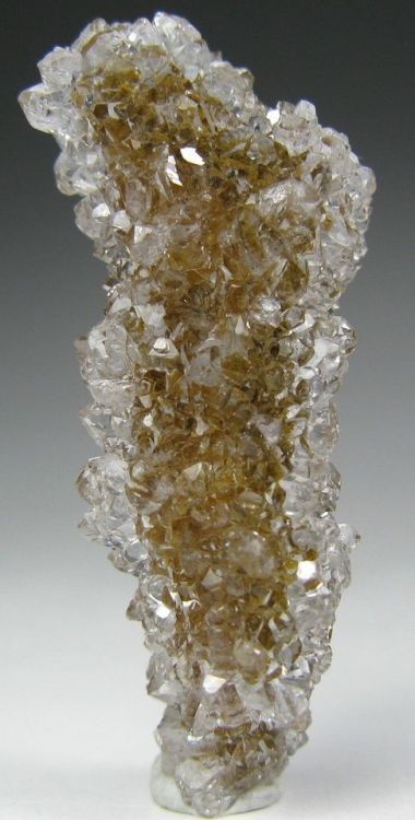 Quartz crystals growing on a Calcite stalactite - Charcas, Mexico