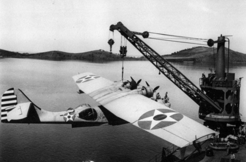 usaac-official: A crane hoists a damaged PBY aboard USS Tangier (AV-8), 6 May 1942