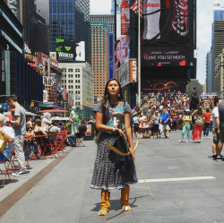 zeppelin-rules:    Naelyn Pike, a 16-year-old member of the Chiricahua Apache tribe, demonstrated in Times Square on Friday against a land swap between the federal government and a copper company that could affect land the protestors hold sacred.NY Times