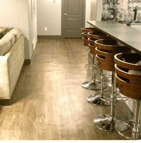 Underground In DenverLarge Modern Underground Basement With Gray Walls And A Medium-toned Wood Floor.