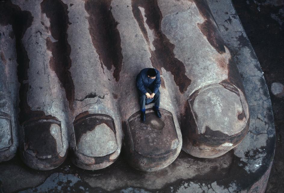 “ ‘80. Sichuan province, China. The foot of an 8th century buddhist statue that stands 72 metres high. Photo by Bruno Barbey.
”