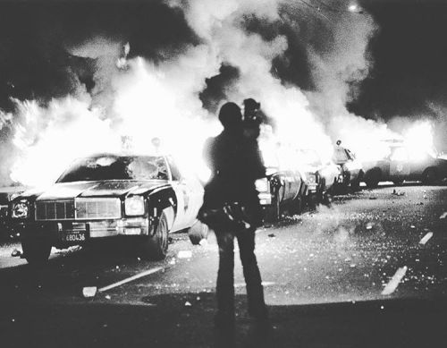 Police cruisers afire during the White Night Riots, San Francisco, California, May 21, 1979. Photo b