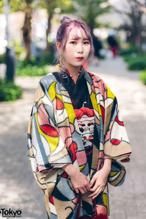 Japanese fashion students Yui and Lina on the street in Tokyo. Yui is wearing a kimono with kitten-h