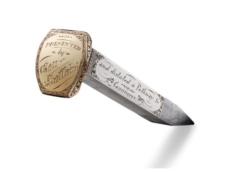 A STEEL RAILROAD SPIKE CLAD IN GOLD AND SILVER USED IN THE CEREMONY MARKING THE COMPLETION OF THE TRANSCONTINENTAL