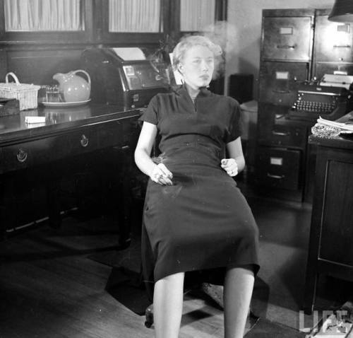 Apparently the wrong way to smoke at the office(Joseph Scherschel. 1949)