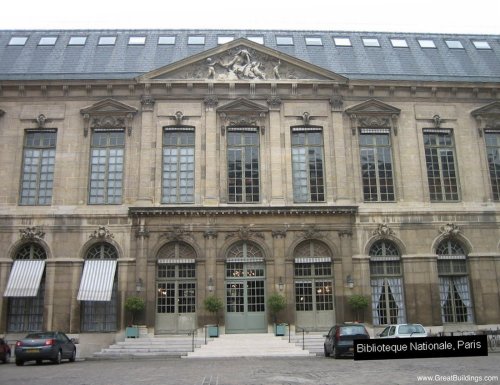 Exterior view of the Bibliotheque Nationale de France at the rue Richelieu complex. Large glass windows enhance the main Reading Room by allowing light to filter though, creating a bright and open space.
Source: "Bibliotheque Nationale by Henri...