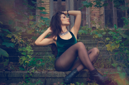 Dark green velvet top with black tights and boots