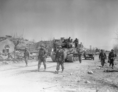 The first tanks and troops of the1stCavalry Division enter the shell-scarred city of Chuncheon, afte