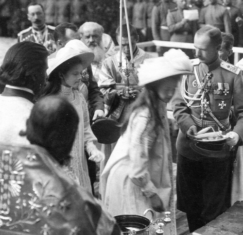 Grand Duchesses Olga and Tatiana laying brigs for the building of a new church