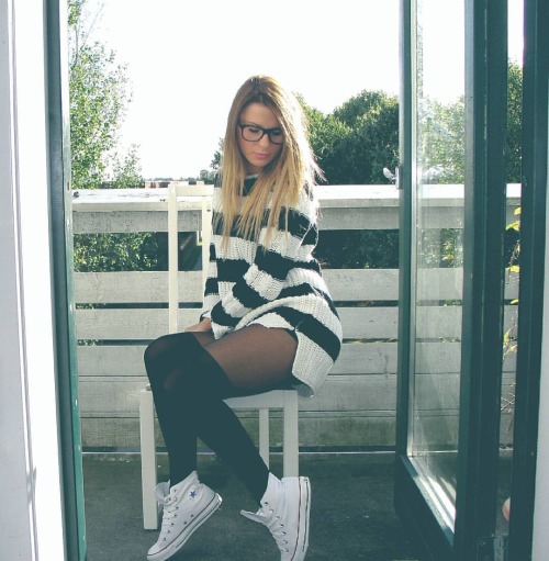 razumichin2: On the balcony in knitted striped sweater dress, black tights and white Converse