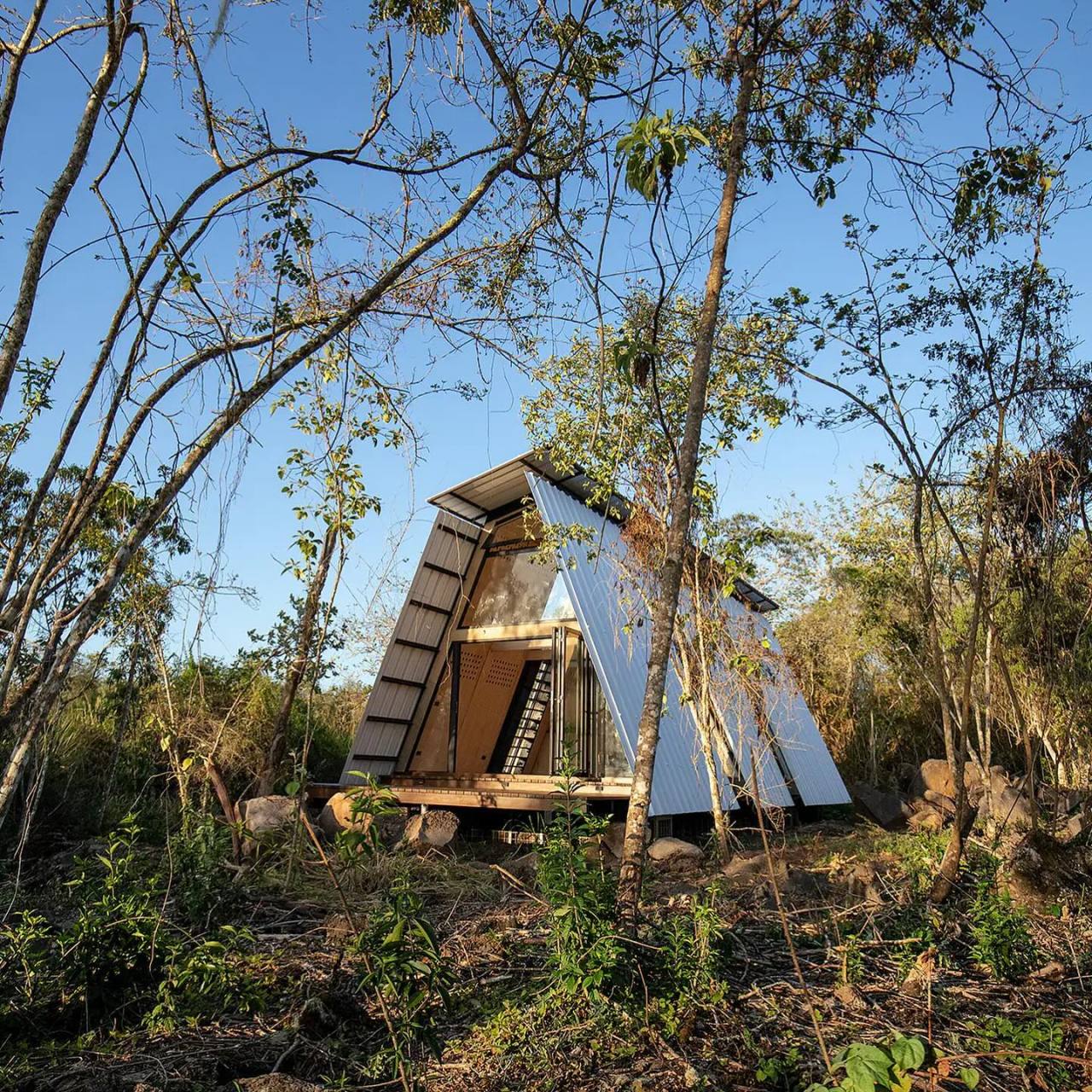 A prefab A-Frame named @huaira.ec located in the Galápagos Islands.  Photographs by @jag_studio More photos on @cabinporn.