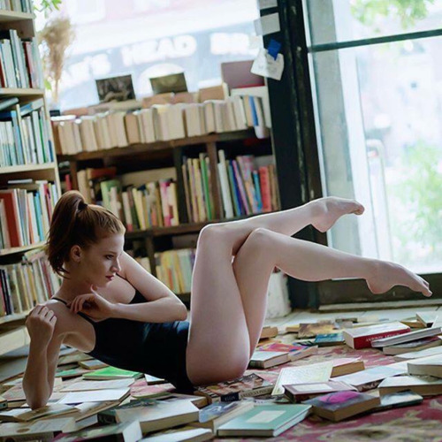 Sarah Hay with books, Bushwick, Brooklyn. Ballerina Project. Bodysuit by Wolford.Sarah Hay (born 198