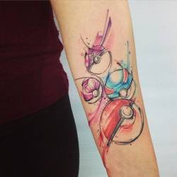 tattoofilter:  Watercolor style pokéball tattoos on the forearm. Tattoo artist: Adrian Bascur