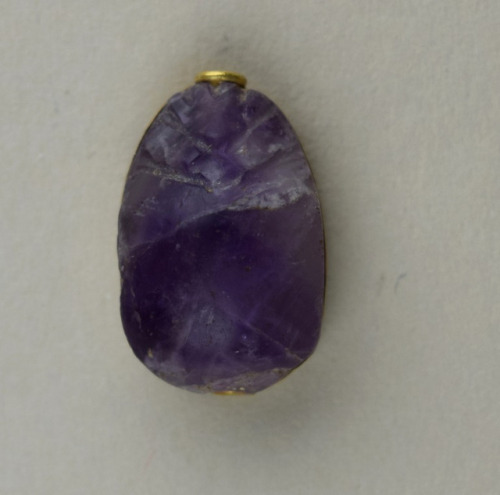 grandegyptianmuseum:Amethyst scarabAmethyst scarab with gold frame around base and hole piercing. Se
