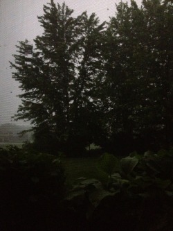 view of a storm through a basement window.