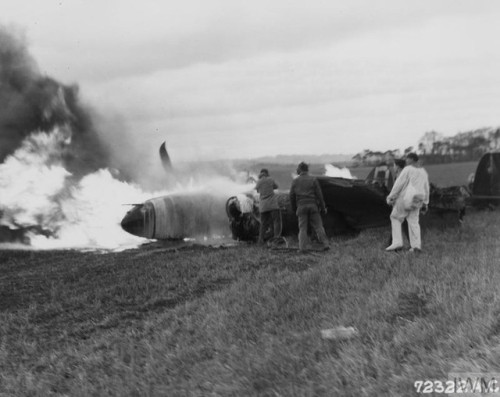 Fire crews attend to the wreckage of a Lockheed P-38 Lightning, anAmerican fighter aircraft, at RAF 