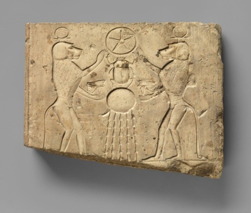 Relief panel showing two baboons offering the wedjat eye to the sun god Khepri, who holds the Underw