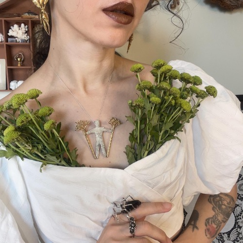 moonandserpent:    Burryman is a wearable sculpture. This necklace consists of burry man covered with burrs, holding two poles decorated with flowers.  Hand carved by Moon and SerpentFor more, please follow my Tumblr or Instagram