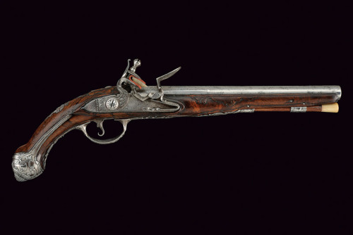 An ornate silver mounted flintlock pistol crafted by G.M. Logia, Brescia, Italy, mid 18th century.