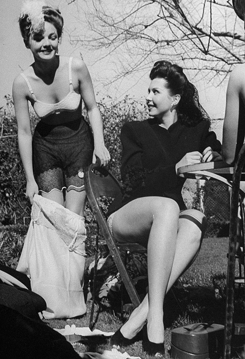 Anne Baxter and Ann Miller during a strip poker game held to raise clothing for a UNRRA drive (1945) photographed by Peter Stackpole.