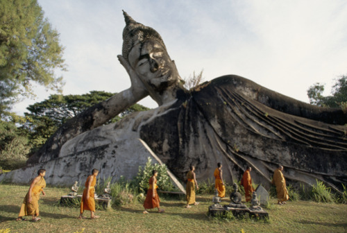 unrar:  A overview of the Wat Xieng Khuan Temple Park with Monks passing by, Laos, Paul Chesley.