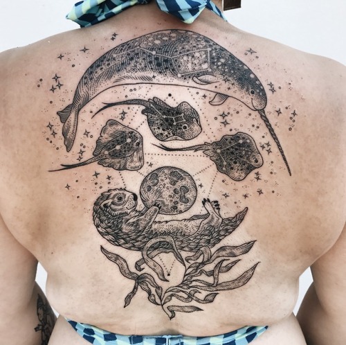 Cosmic narwhal carrying the Big Dipper with stingrays, swimming over the sea otter holding up the mo