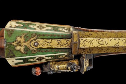 An ornate Turkish miquelet musket decorated with gold, silver, brass, and coral, 19th century.
