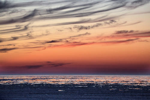 briargeese:Lake Michigan sunset, still ice covered at the shoreline.