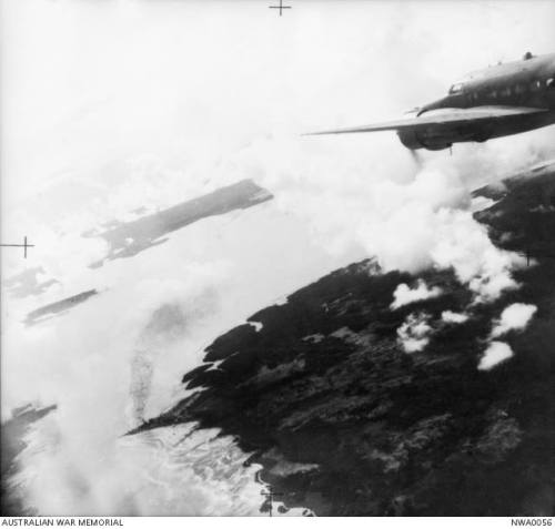 An RAAF Lockheed Hudson over Dobo, a Japanese float plane base. Aru Islands, Maluccas, Dutch East In