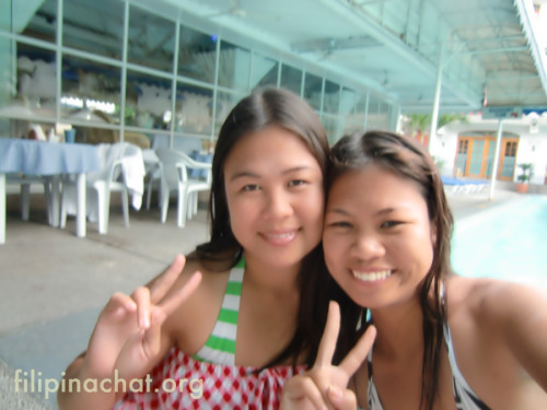 Two Pinays having fun on their day off while picknicking next to poolside at Clarkton Hotel.