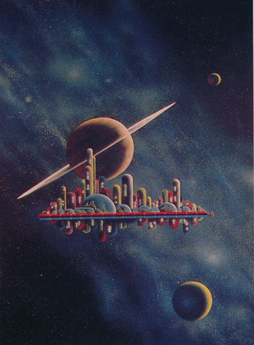 A multi-colored city of tubes floats in space, with a ringed planet in the background.