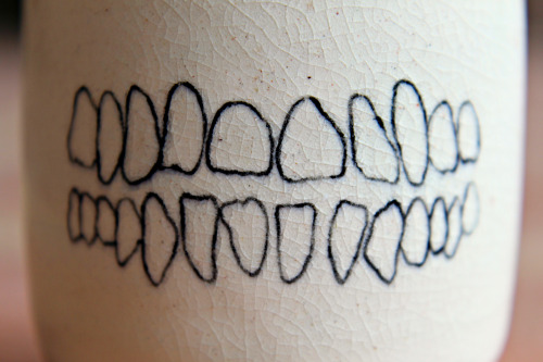 xcatalicious:  This one’s for my tea drinking homies! Wheel thrown porcelain tea cup with human teeth and dog jaw bone hand painted on opposite sides covered in a cracking clear glaze. You can buy it right hurrrr if you want…not trying to force anything,