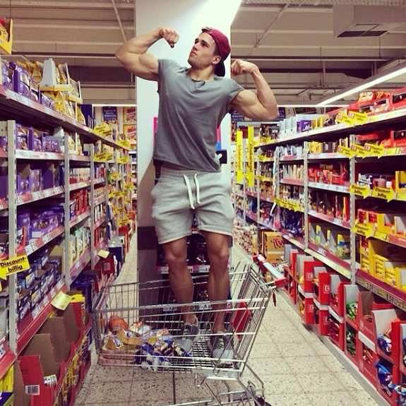 fuckin cocky dude……how bad so u wanna just nail him in the bulge and fuckin suplex him out of that cart????? the dude knows he is hot…..big arms, backward cap, sweat shorts, waist strings hanging off around his bulge, he fuckin flexes 2 show off but...