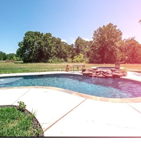 Rustic PoolExample Of A Mid-sized Mountain Style Backyard Stone And Custom-shaped Natural Hot Tub Design