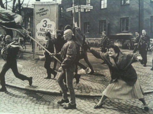 dreadpiratekhan: dreadpiratekhan: A Swedish woman hitting a neo-Nazi protester with her handbag. The