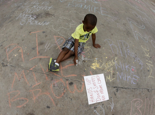 yahoonewsphotos: The peaceful side of the Ferguson protests Nightly chaos in the St. Louis suburb is