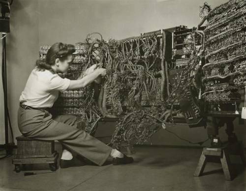 An engineer wiring an early IBM computer, porn pictures