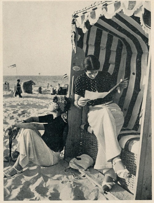 Fashionable ladies reading and loafing at the beach, circa 1938.“&hellip;vicinity to the sea is desi