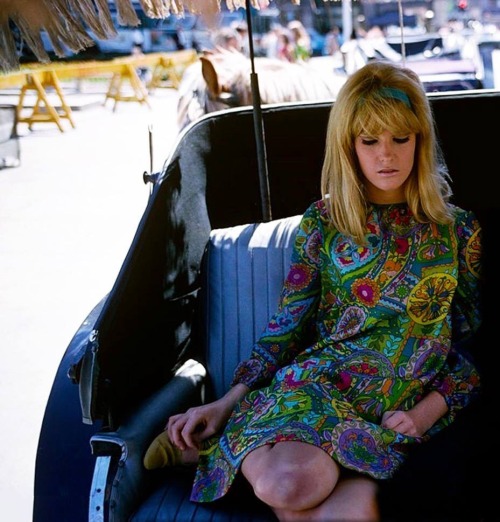 isabelcostasixties:a model in a mini green floral print dress pose in a horse and carriage in Centra
