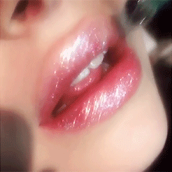 glittery lip gloss being applied onto someone's lips