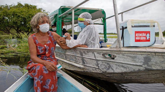 A health worker inoculates 72-year-old Olga D