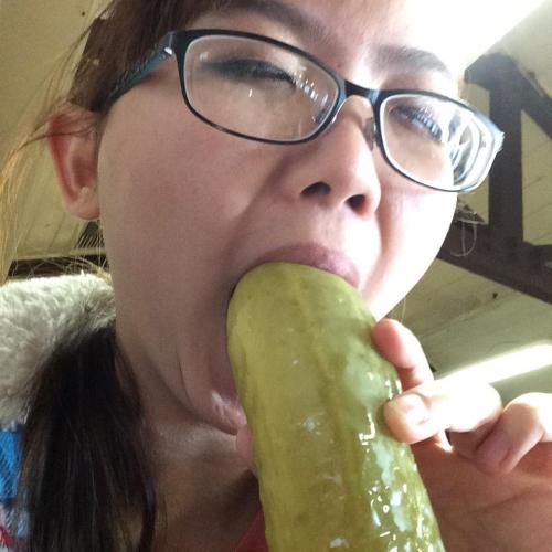 Hot Asian girl sucking on a huge pickle. porn pictures