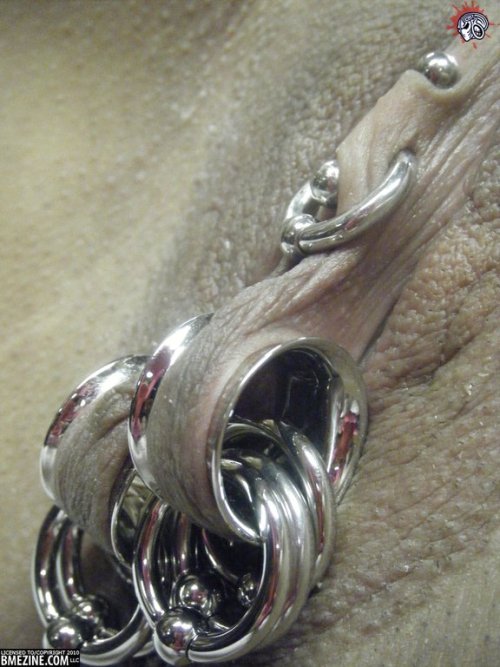 pussymodsgalore: Wow! Enormous gleaming metal flesh tunnels through her labia, each with large metal