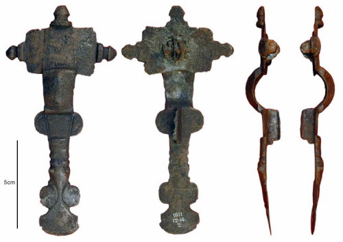 Early Anglo-Saxon cast copper alloy cruciform brooch (c. 475 –550), found in the cemetery sandpit at