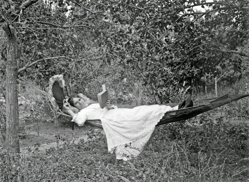 back-then:Lydia Myrtle Williams, reclining in a hammock with a book and a fan. Napier, New Zealandca