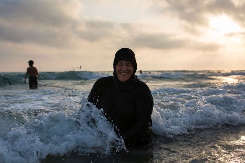 biladal-sham:A Lebanese woman plays in the water on a beach in the southern Lebanese port city of Ty